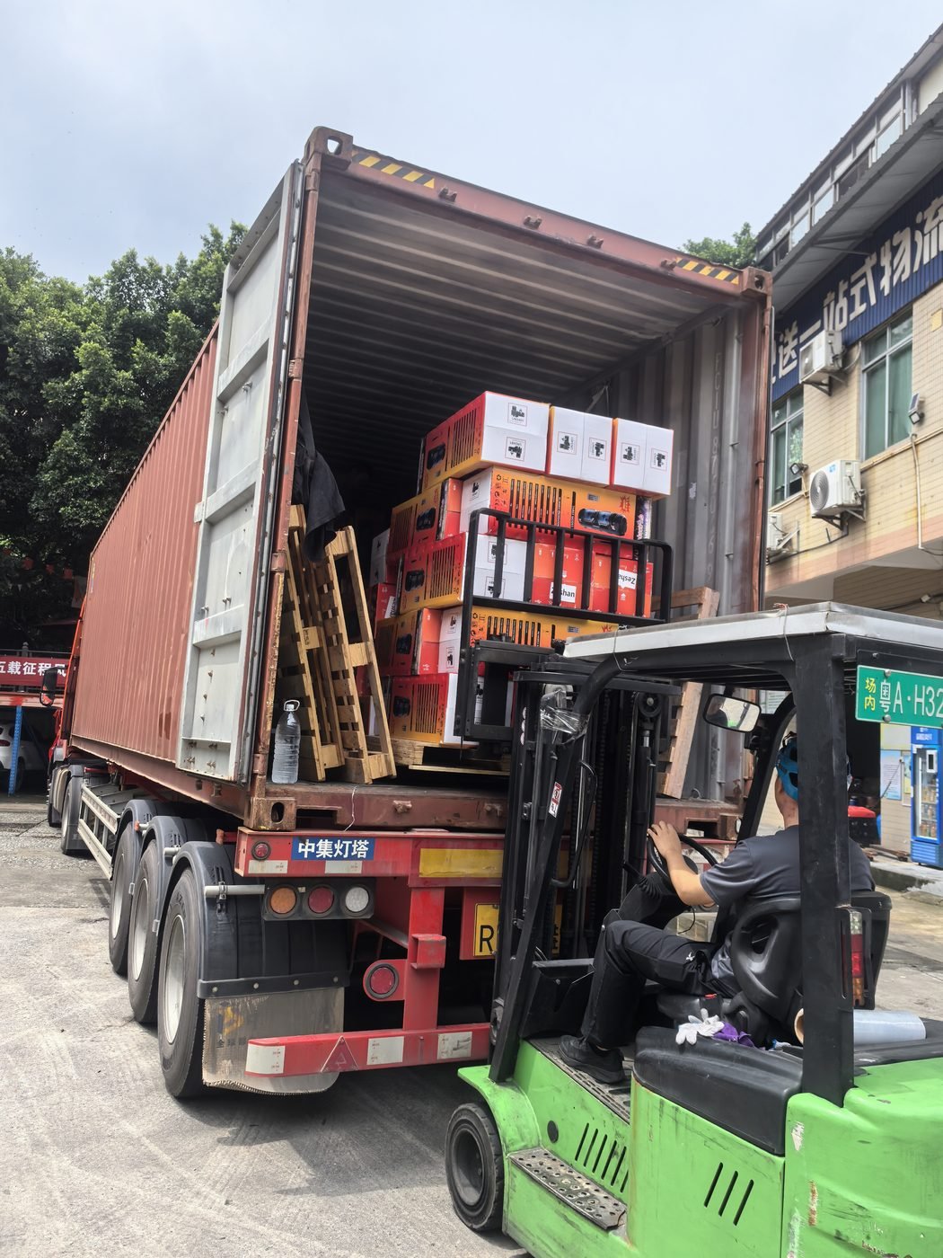 Forklift loading cargo into shipping container at Dongguan