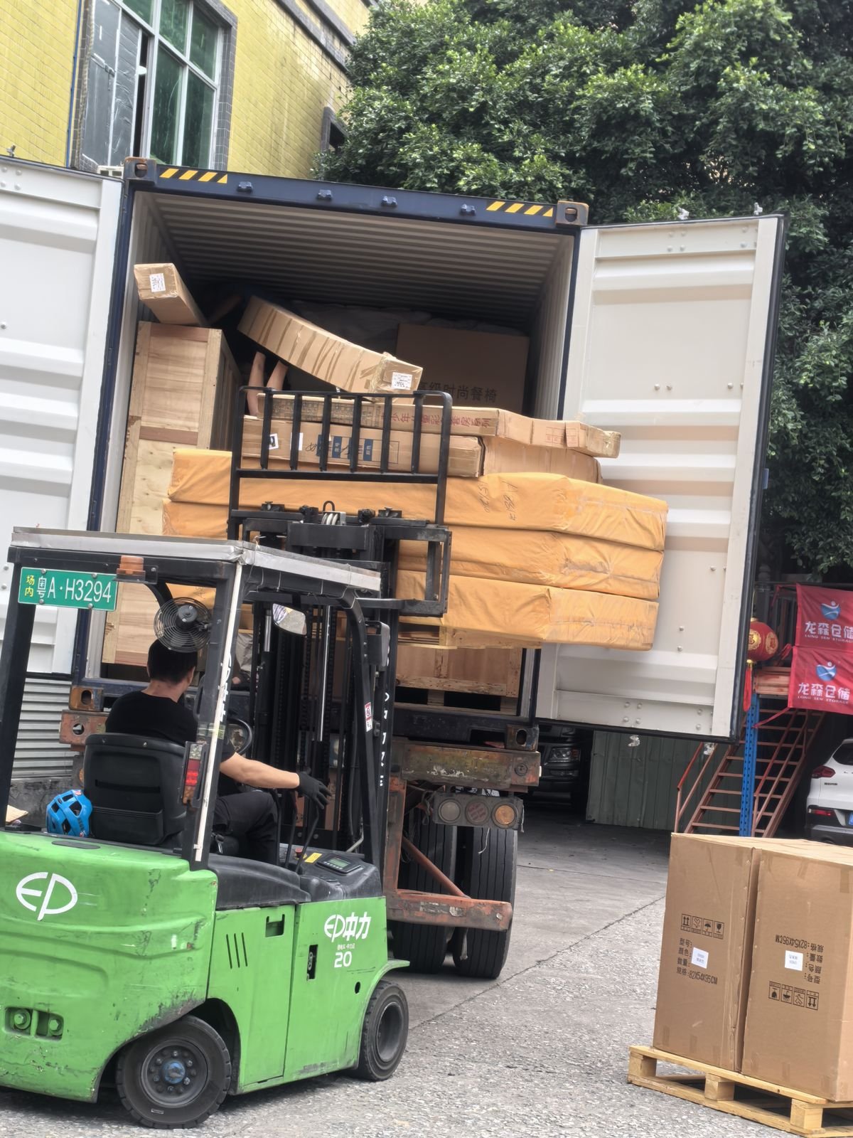 Forklift loading cargo into shipping container in Dongguan, China